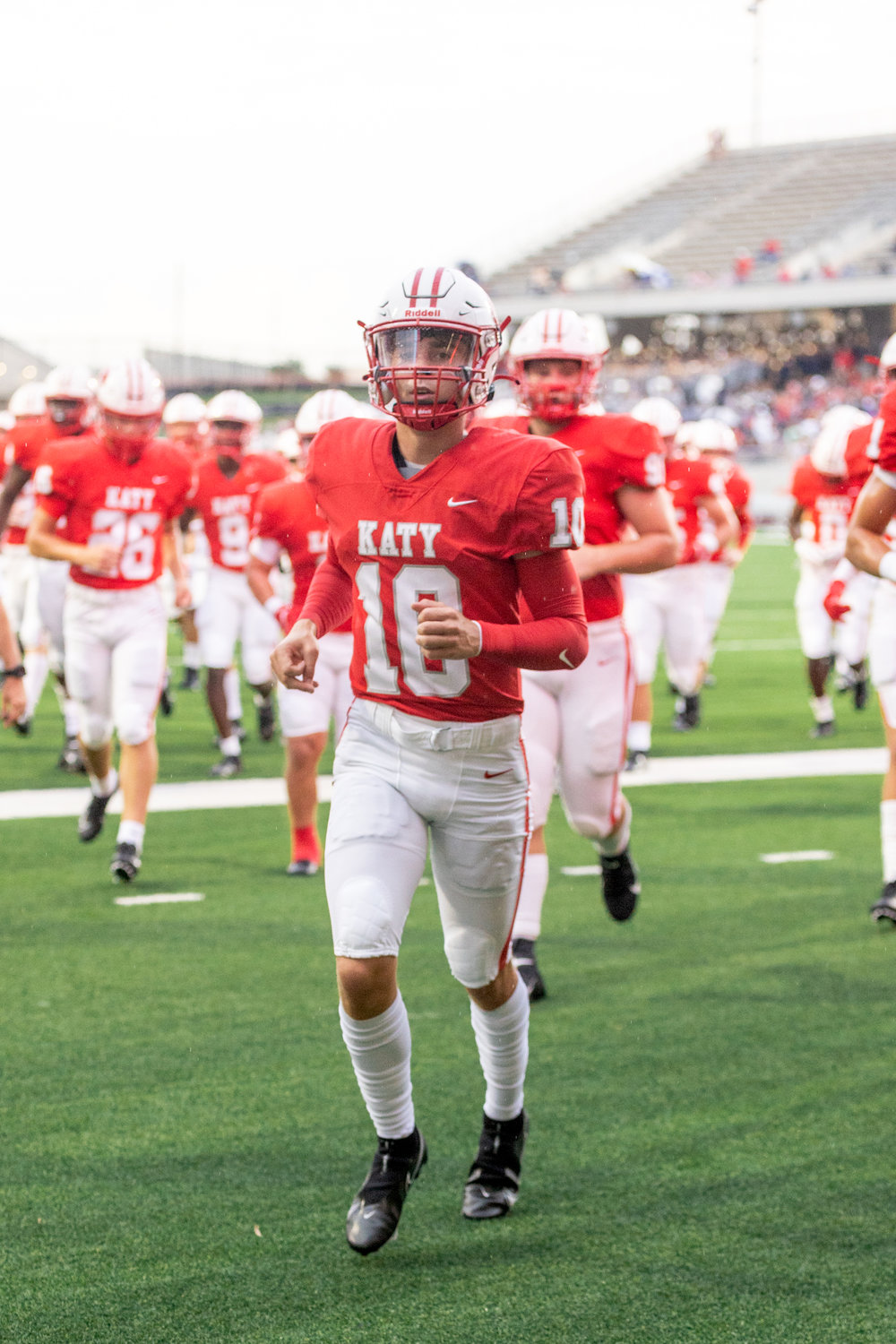 Katy’s Caleb Koger leads his team off the field before Friday’s game between Katy and Atascocita at Legacy Stadium.
